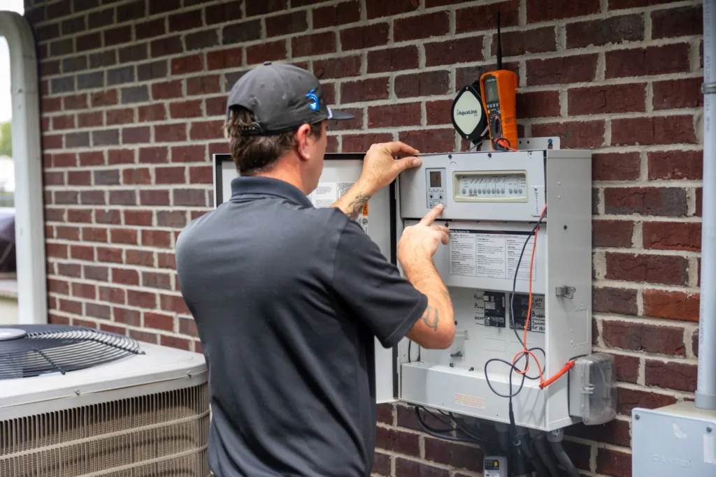 Clarkson Pools technician programming pool control system